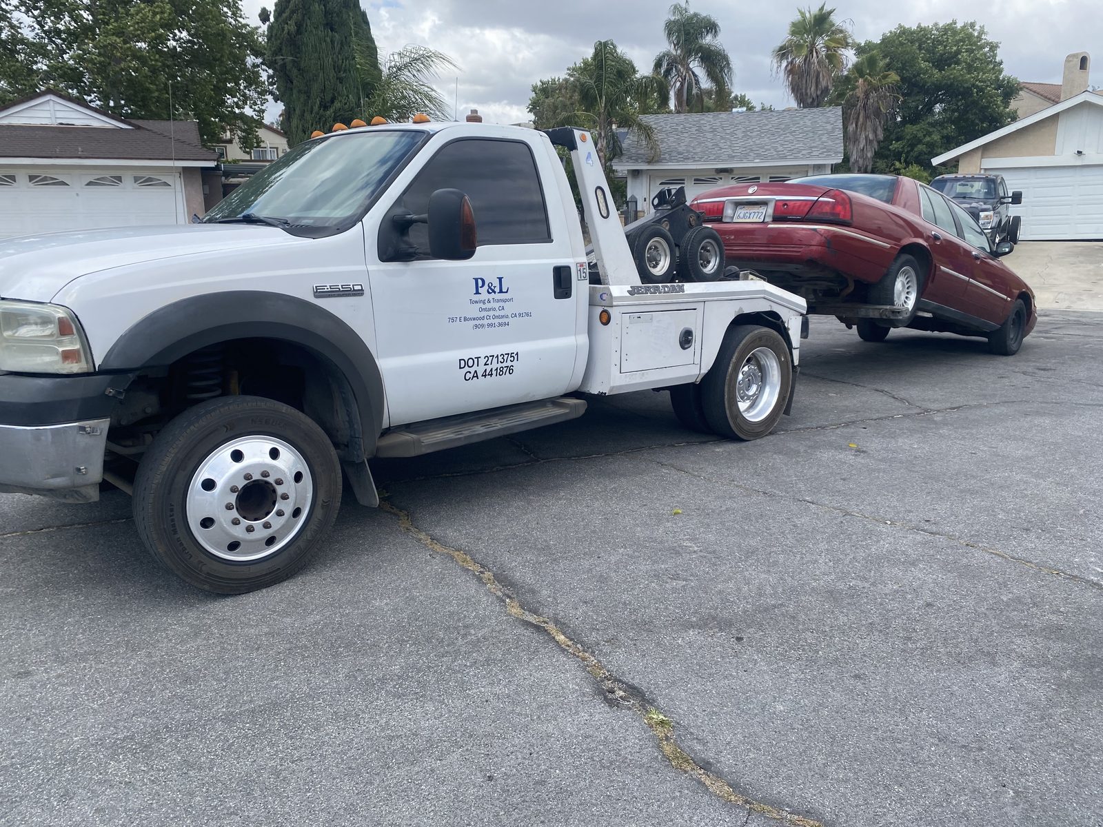 P&L Towing light duty tow truck moving a sedan in Ontario, CA